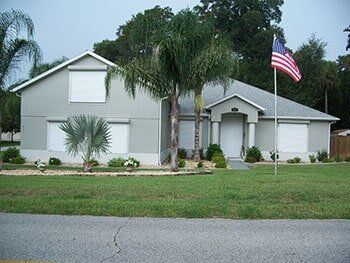 Hurricane Shutters Ormond Beach FL — Front View of White House with Storm Shutter in Ormond Beach, FL