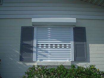 Storm shutter in a window — hurricane shutters Ormond Beach FL in Ormond Beach, FL