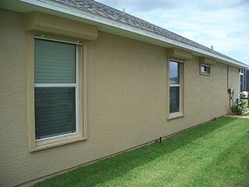 Storm shutter in a side of the house — hurricane shutters Ormond Beach FL in Ormond Beach, FL