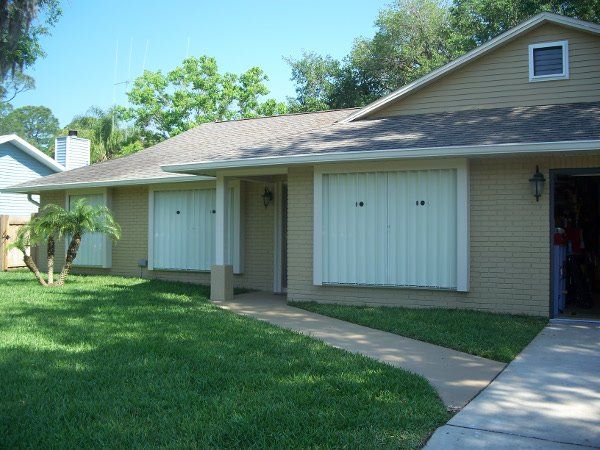 White accordion shutters — hurricane shutters Ormond Beach FL in Ormond Beach, FL