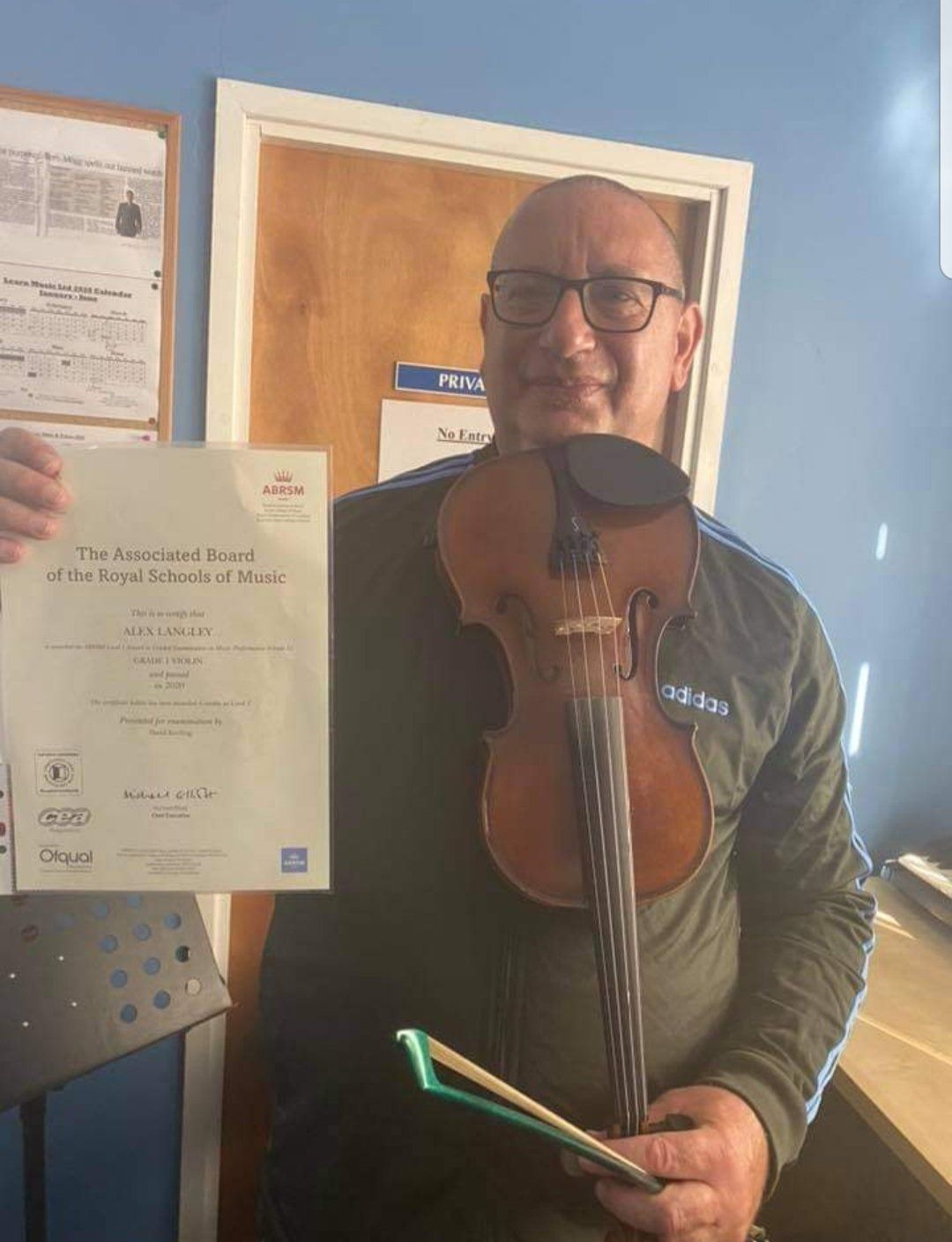 A man taking guitar lessons