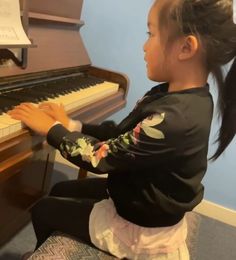 A girl playing a piano