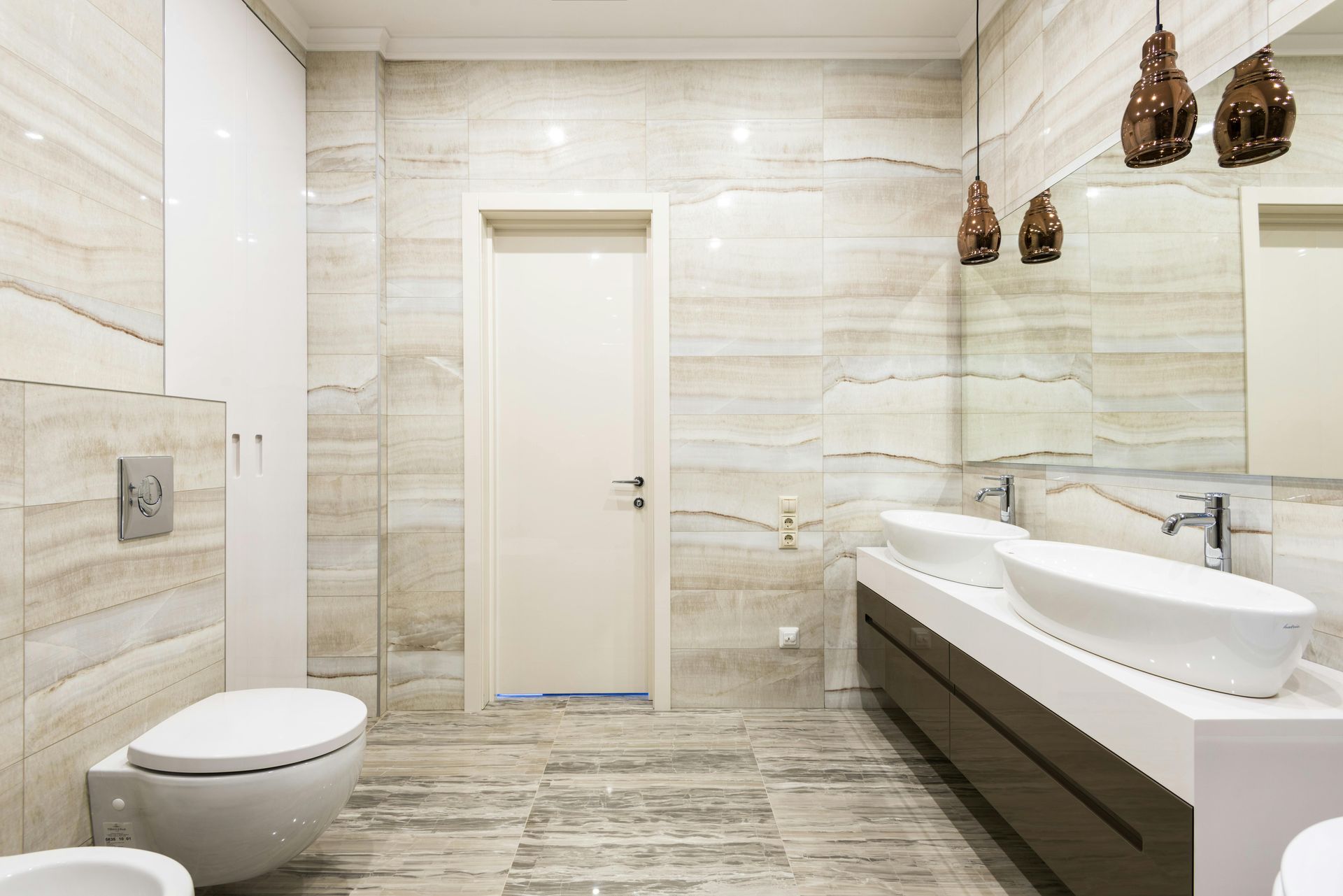 A bathroom with marble tiles and a window