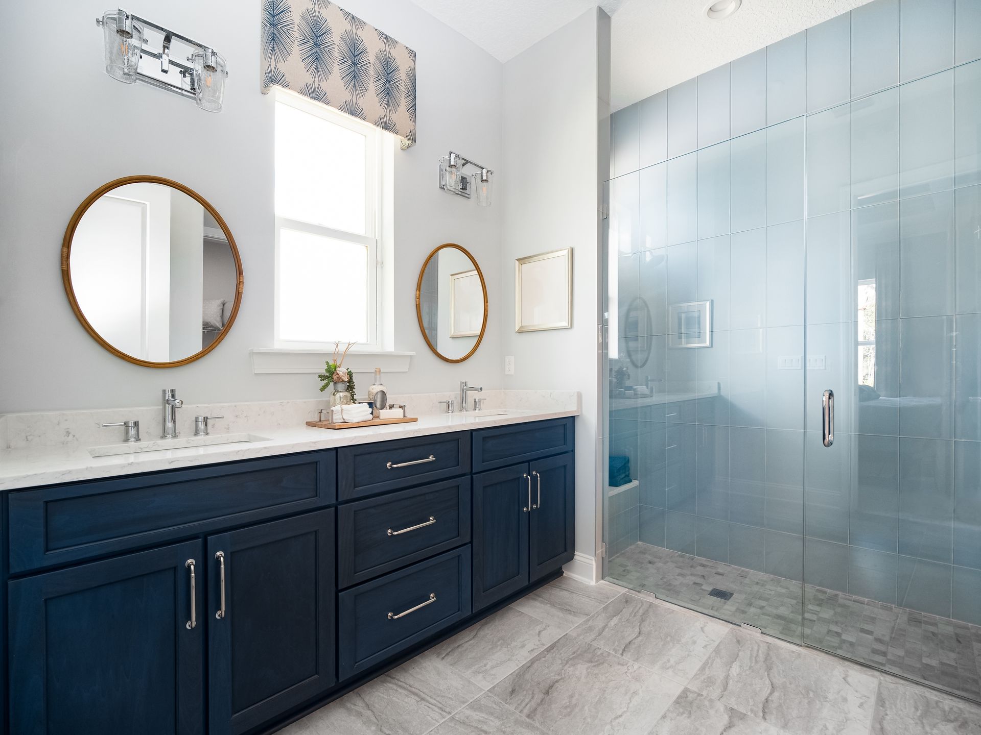 A bathroom with marble tiles and a window