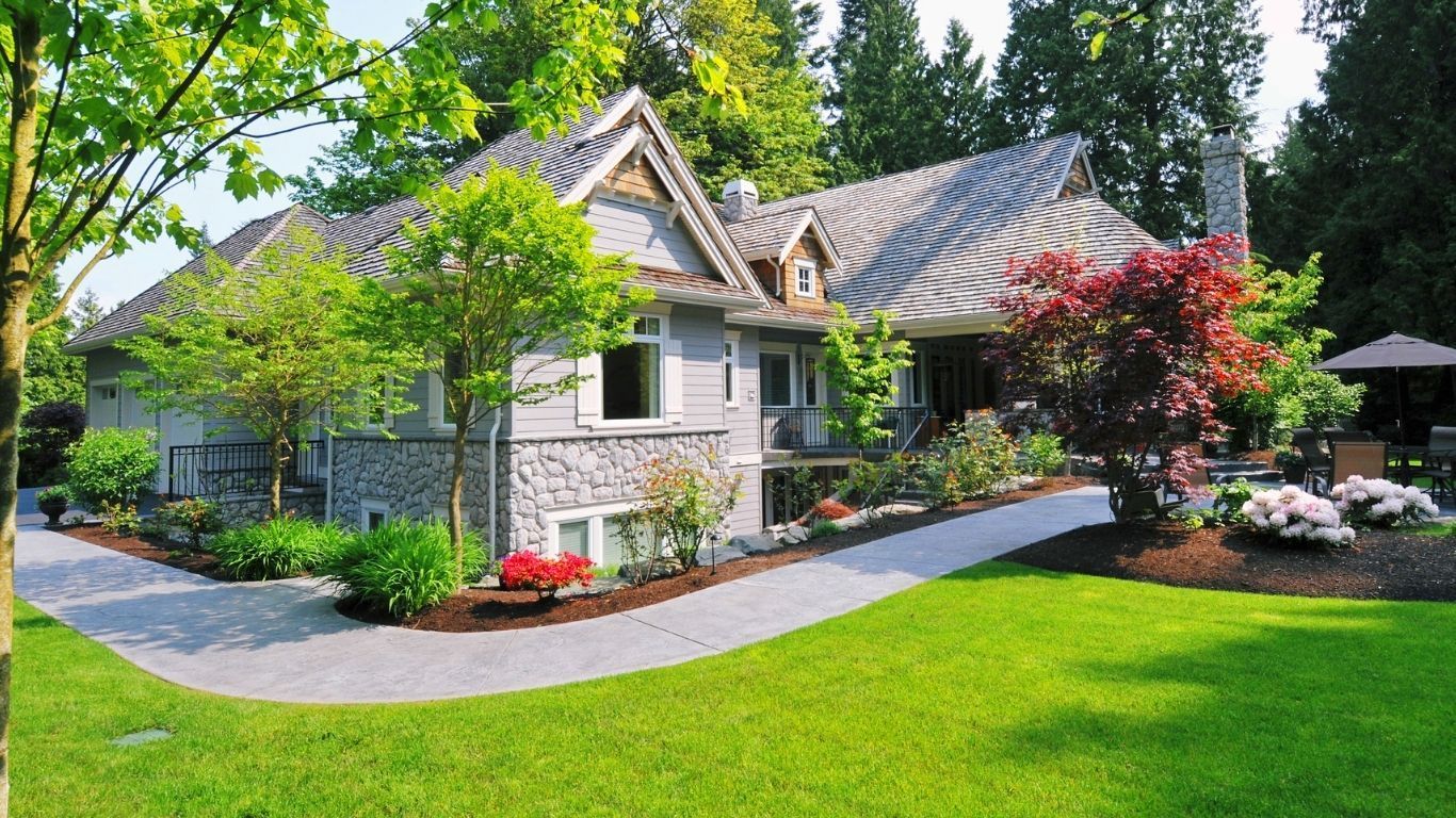 A truck is parked next to a waterfall made of rocks.