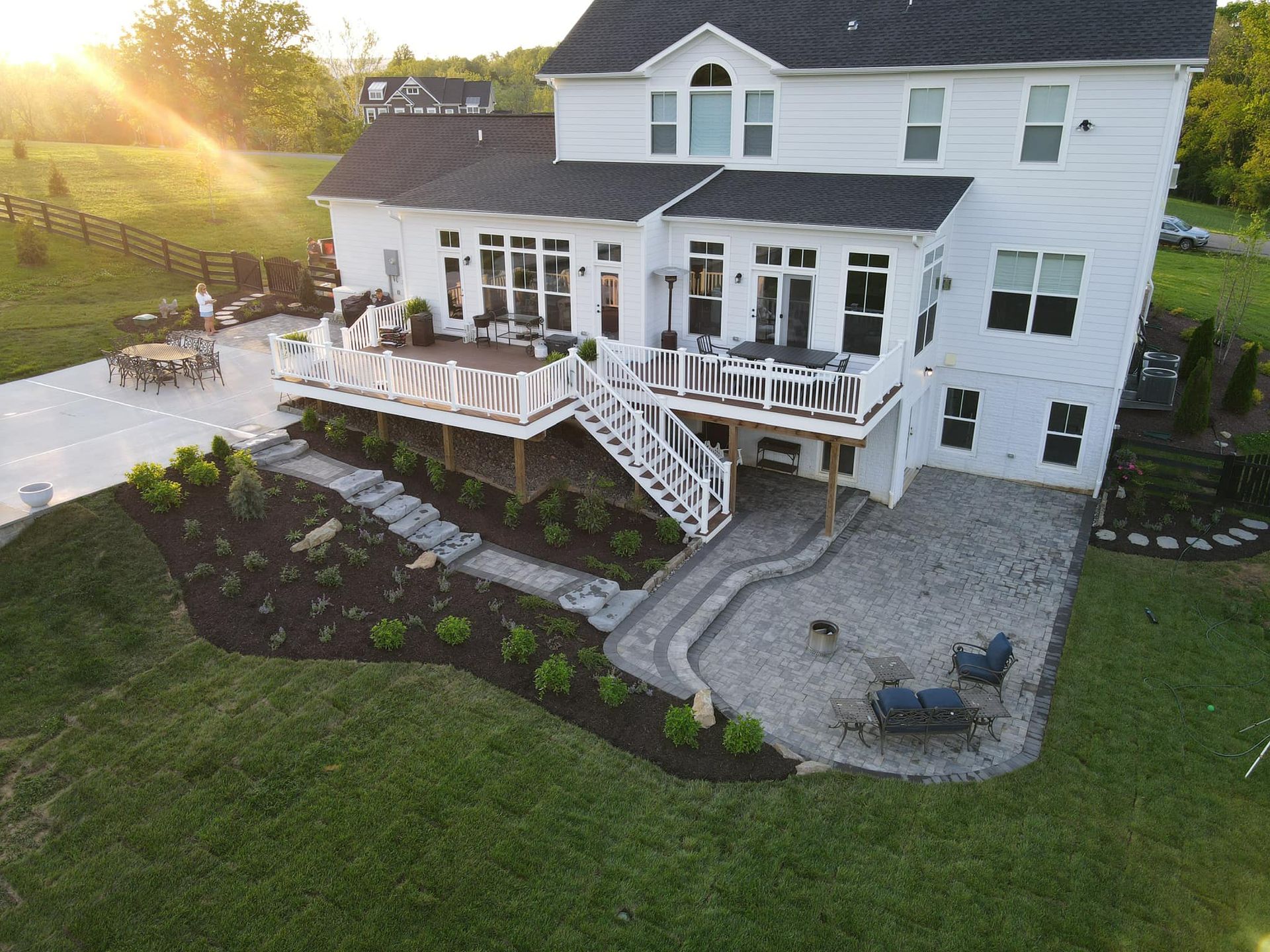 A rooftop garden with lots of potted plants on it.