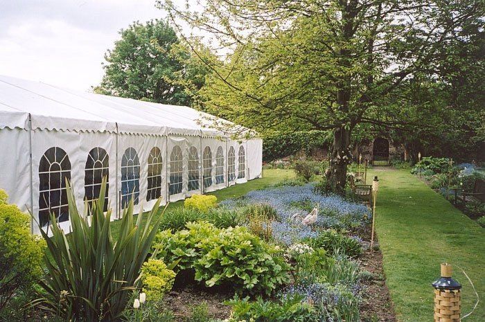 marquee constructed besides a beautiful garden