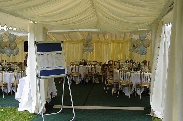 a notice board placed at the entrance of the marquee