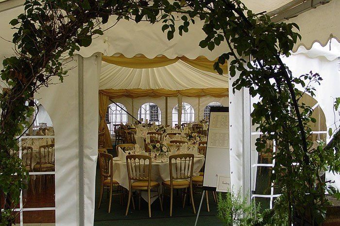 a beautiful entrance with seating arrangements in marquee