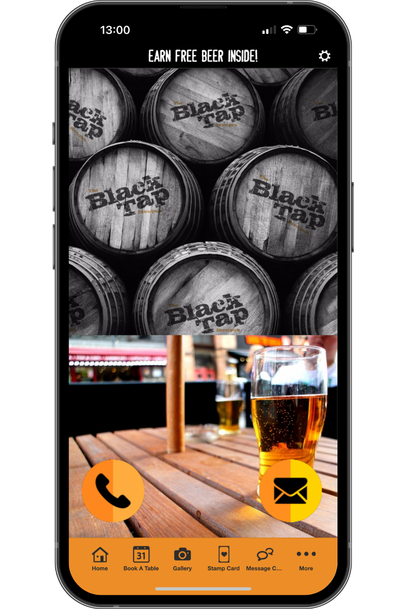 A cell phone with a picture of barrels and a glass of beer on a table.