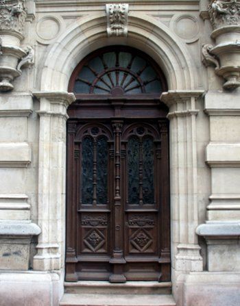 A building with a wooden door and a stone archway