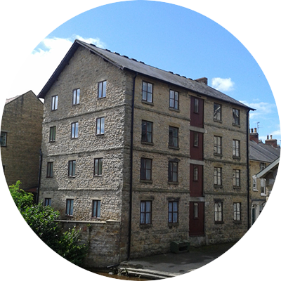 A large stone building with many windows and a roof