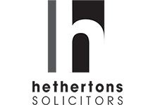 A black and white logo for a company called hethertons solicitors.