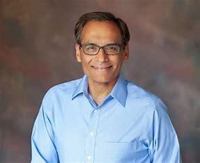 A silhouette of a person in a circle on a white background.