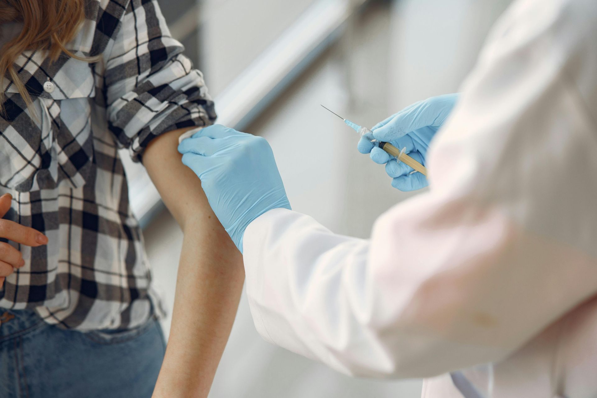 A woman is getting a vaccine from a doctor.