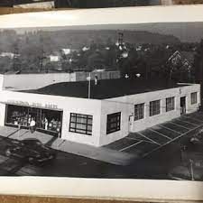 A Black and White Photo of A Large White Building with Cars Parked in Front of It | Oregon City, OR | Clackamas Auto Parts