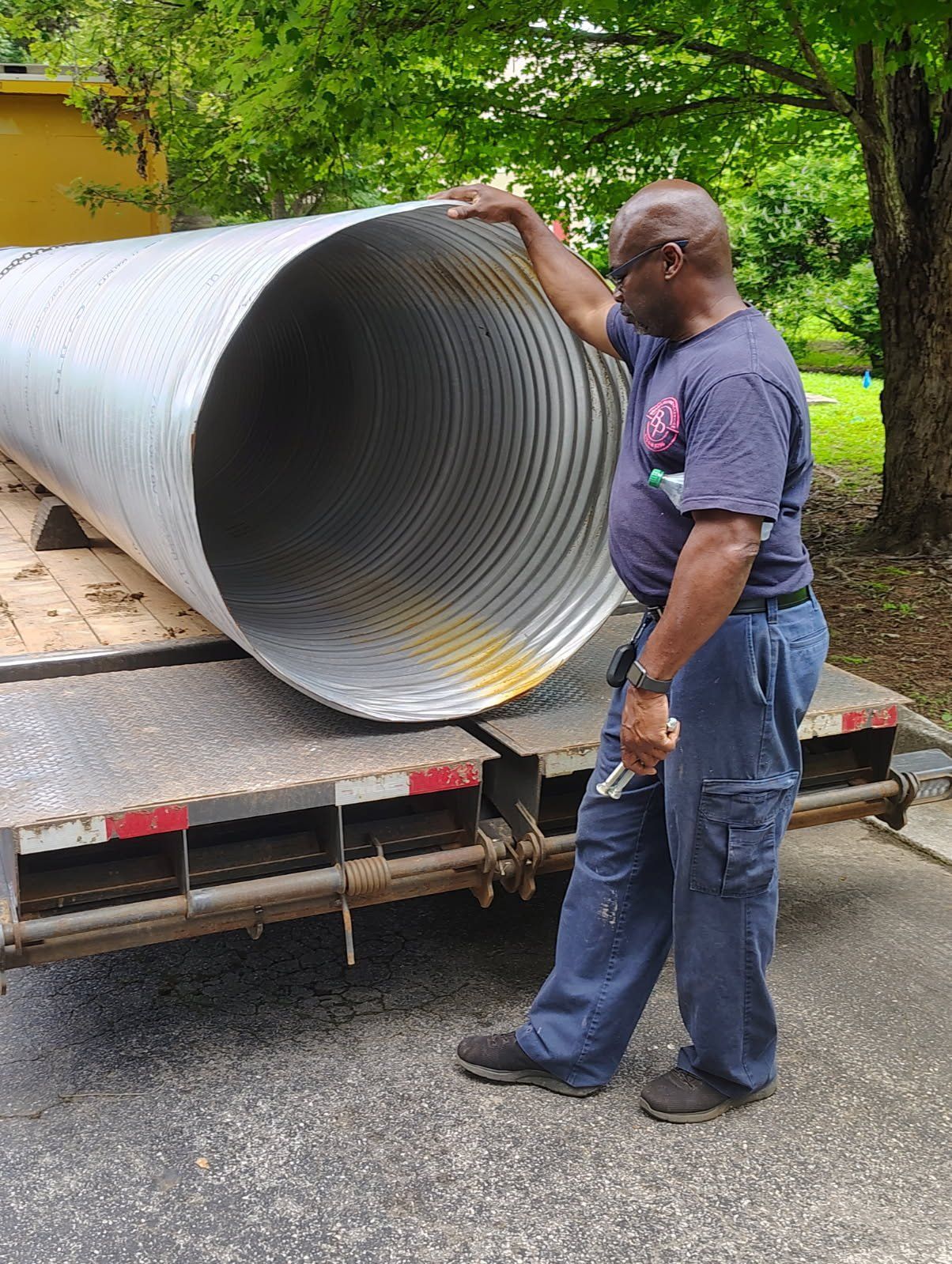 White van with company logo parked outside. Contact info on the van.