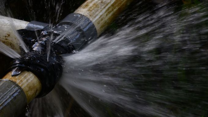 Leaking water pipes with water spraying out.