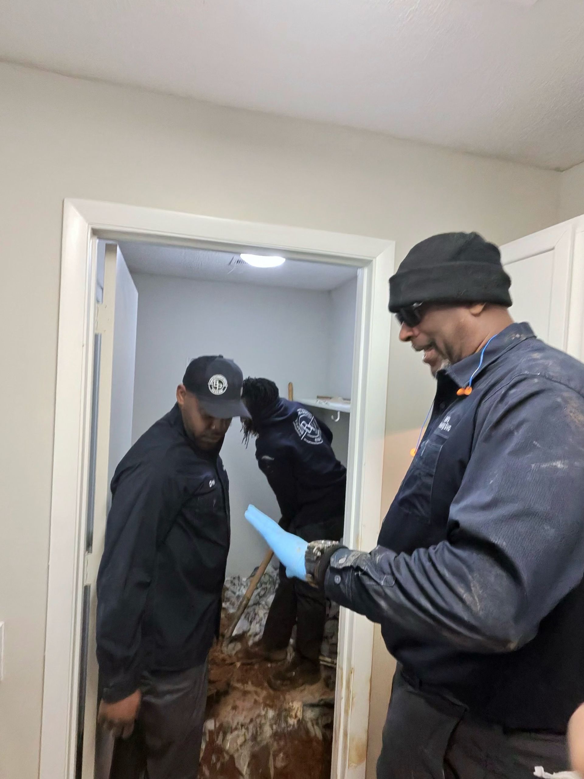 White service van with company logo parked outside a building, contact number visible.