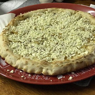 A Pizza With Cheese On Top Of It Is On A Red Plate — Bel-Air Pizza In Port Macquarie, NSW