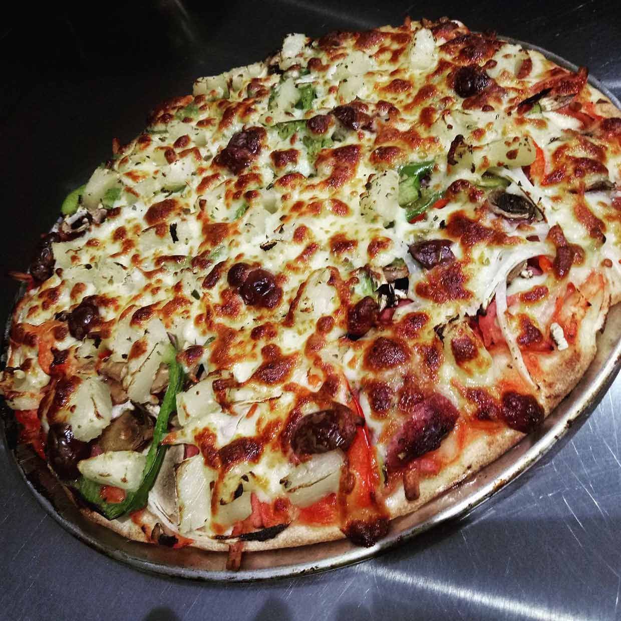 A Pizza With A Lot Of Toppings On It — Bel-Air Pizza In Port Macquarie, NSW
