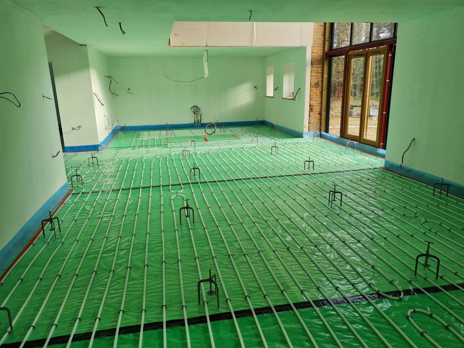 Floor prepared and underfloor heating pipes installed, ready for the liquid screed.