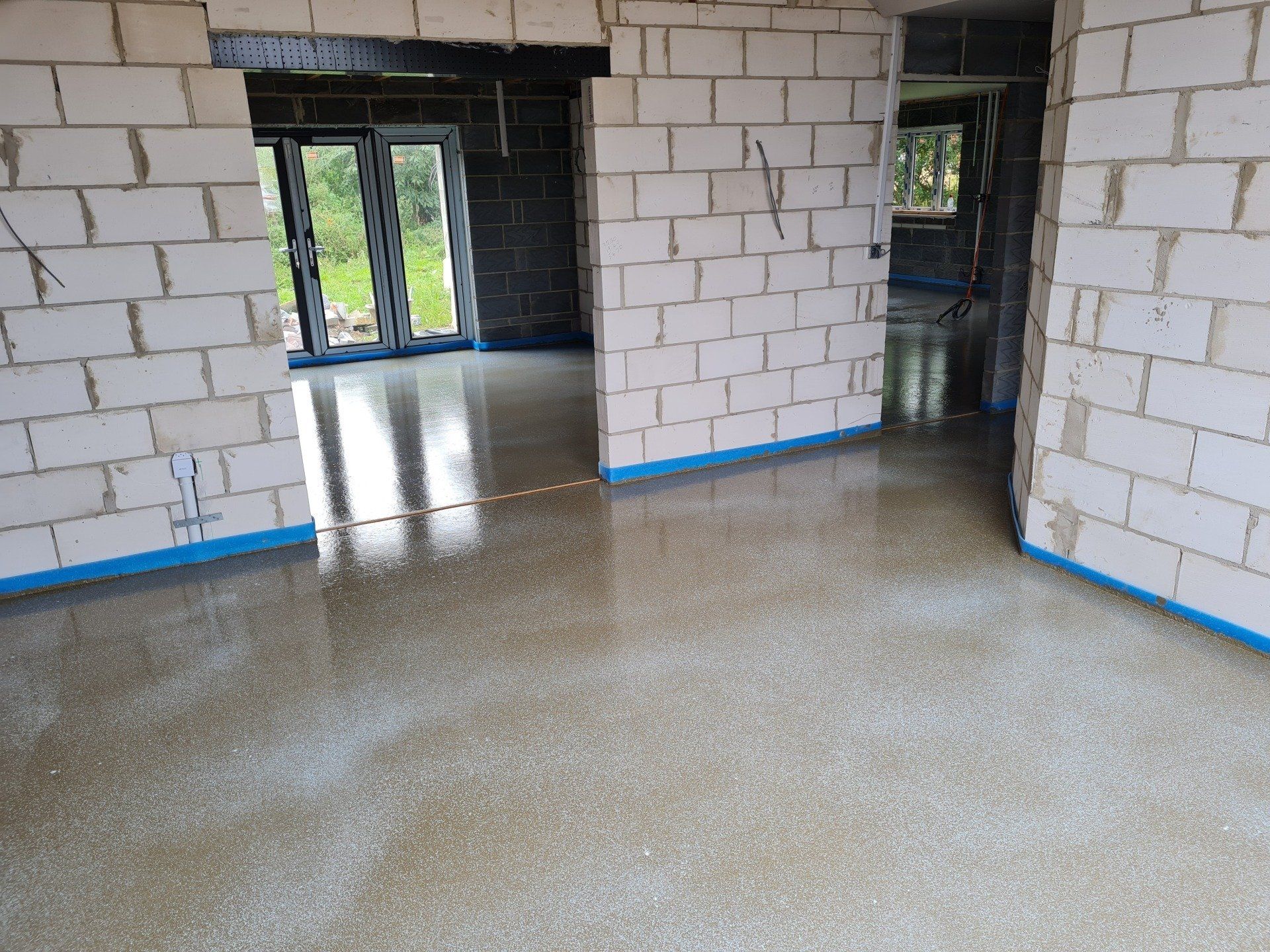 Cemfloor liquid screed installed with door breaks in place.