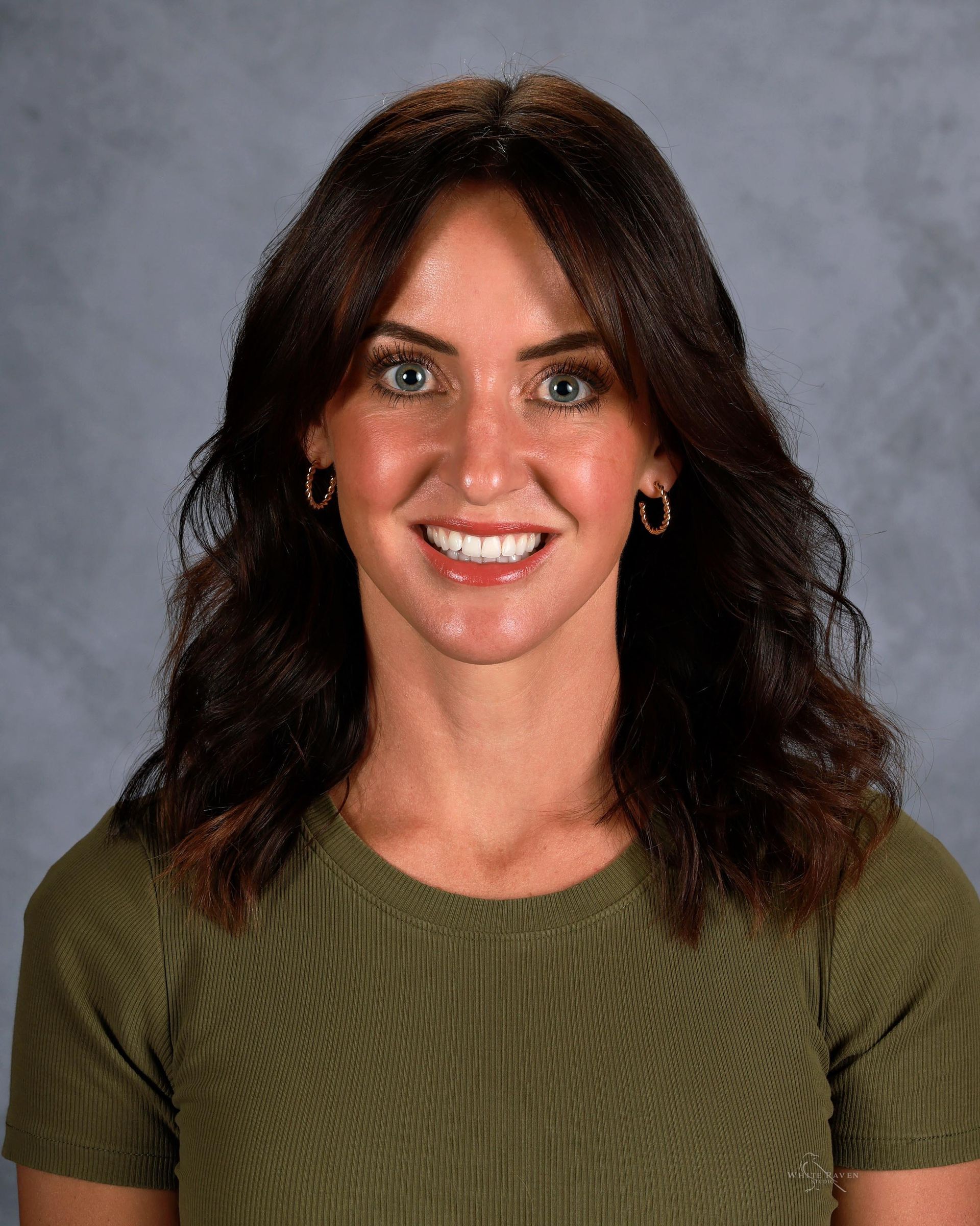 A woman in a black shirt is smiling for the camera