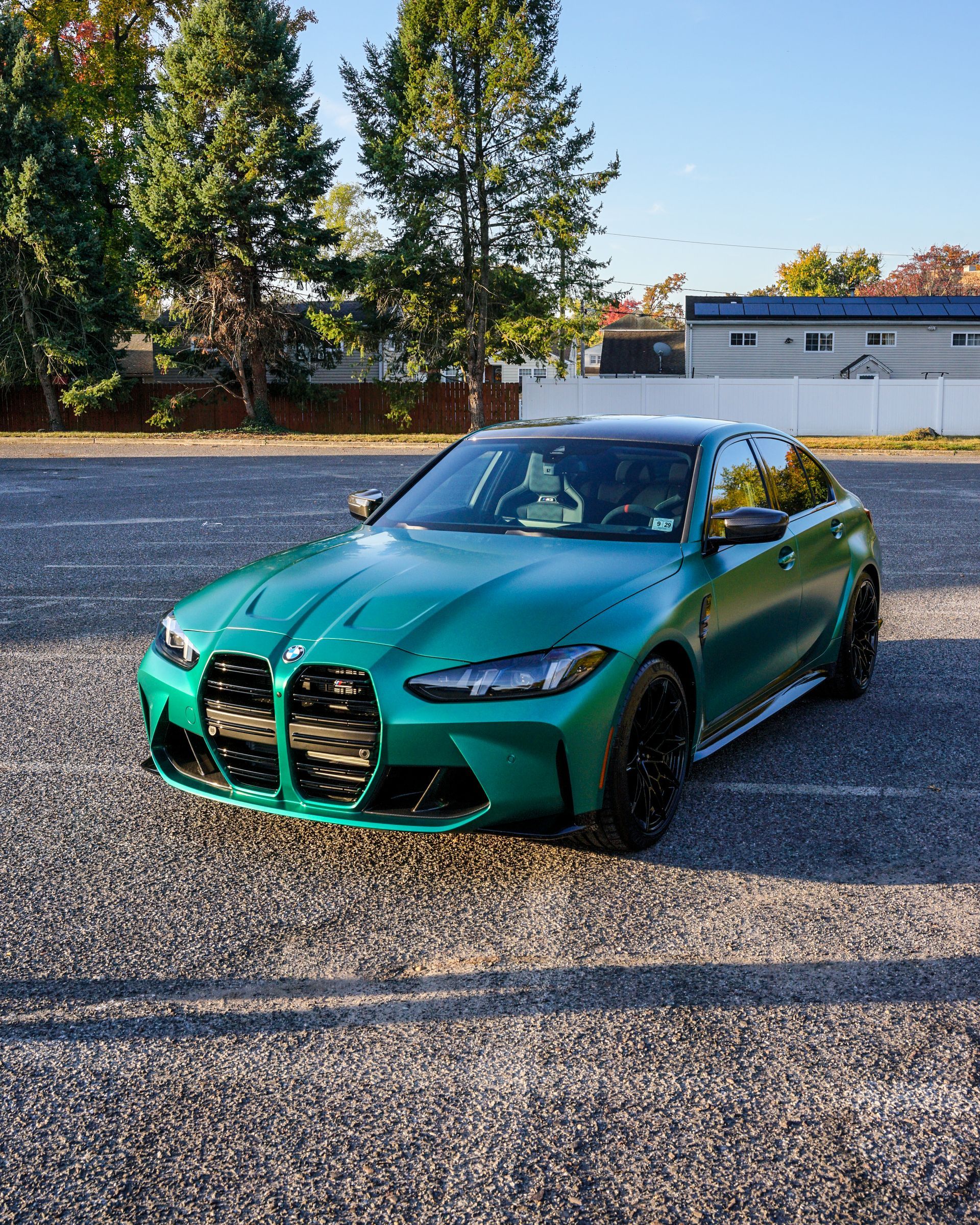 A silver corvette is parked in a parking lot.