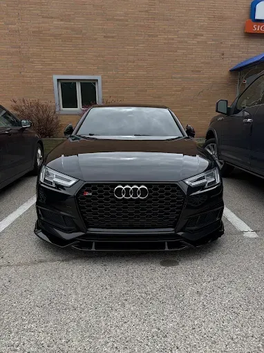 Black Audi S4 sedan with PPF paint protection film applied, showcasing deep gloss finish on hood and
