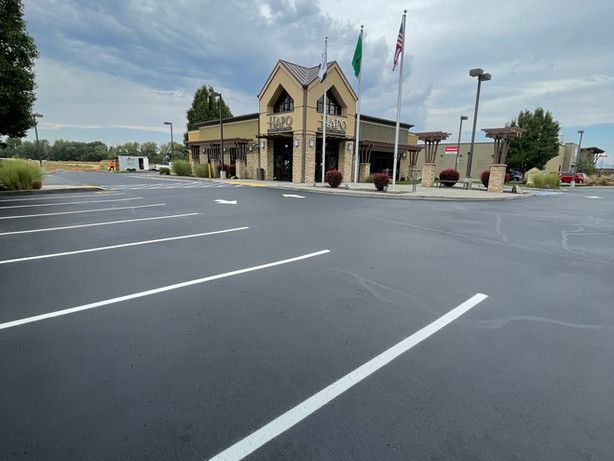 A parking lot with a building in the background