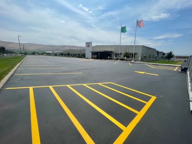 A parking lot with yellow lines and a handicapped parking spot
