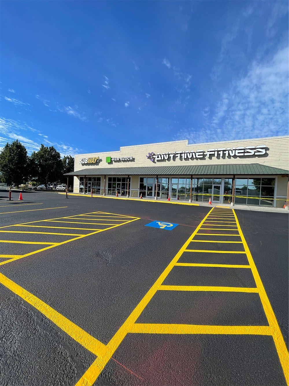 A gym with a handicapped parking spot in front of it