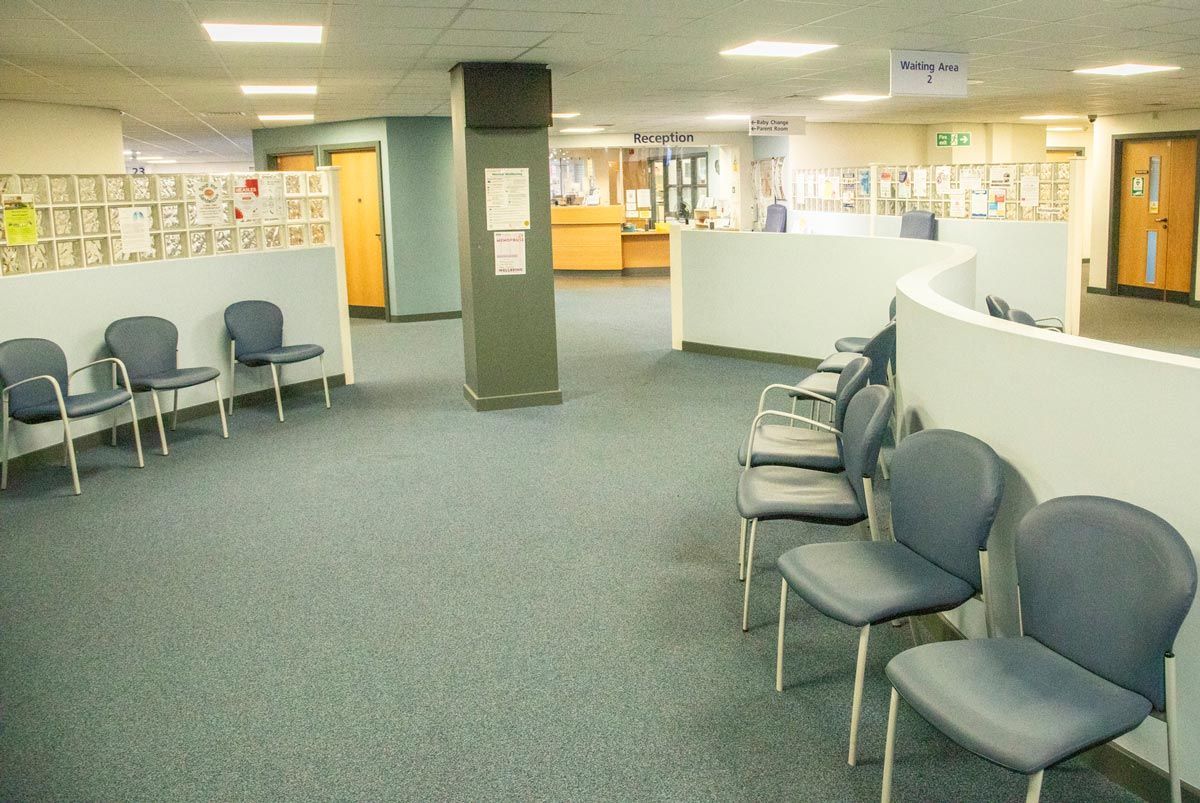 A waiting room with a lot of chairs in it