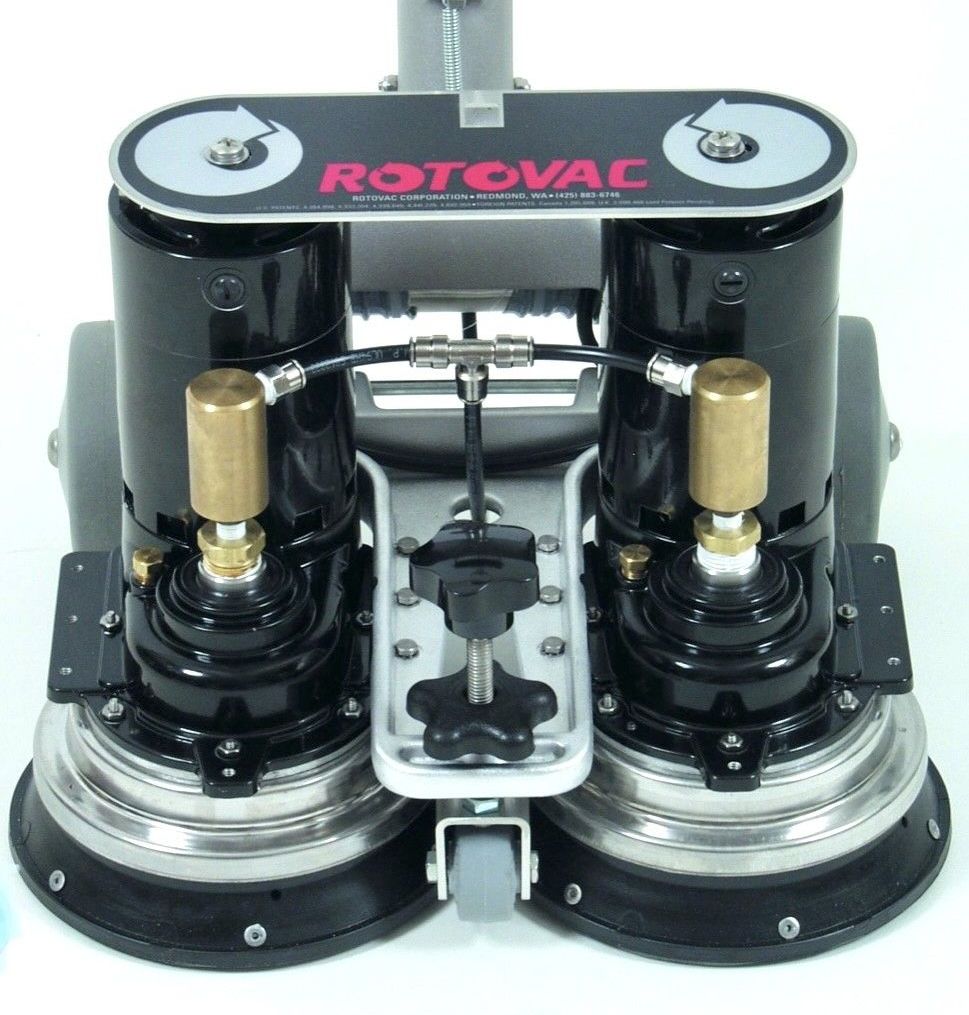 A person is using a vacuum cleaner to clean a carpet in a living room.