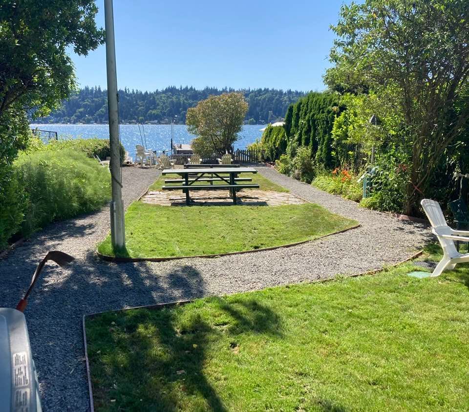 A picnic table is in the middle of a lush green field