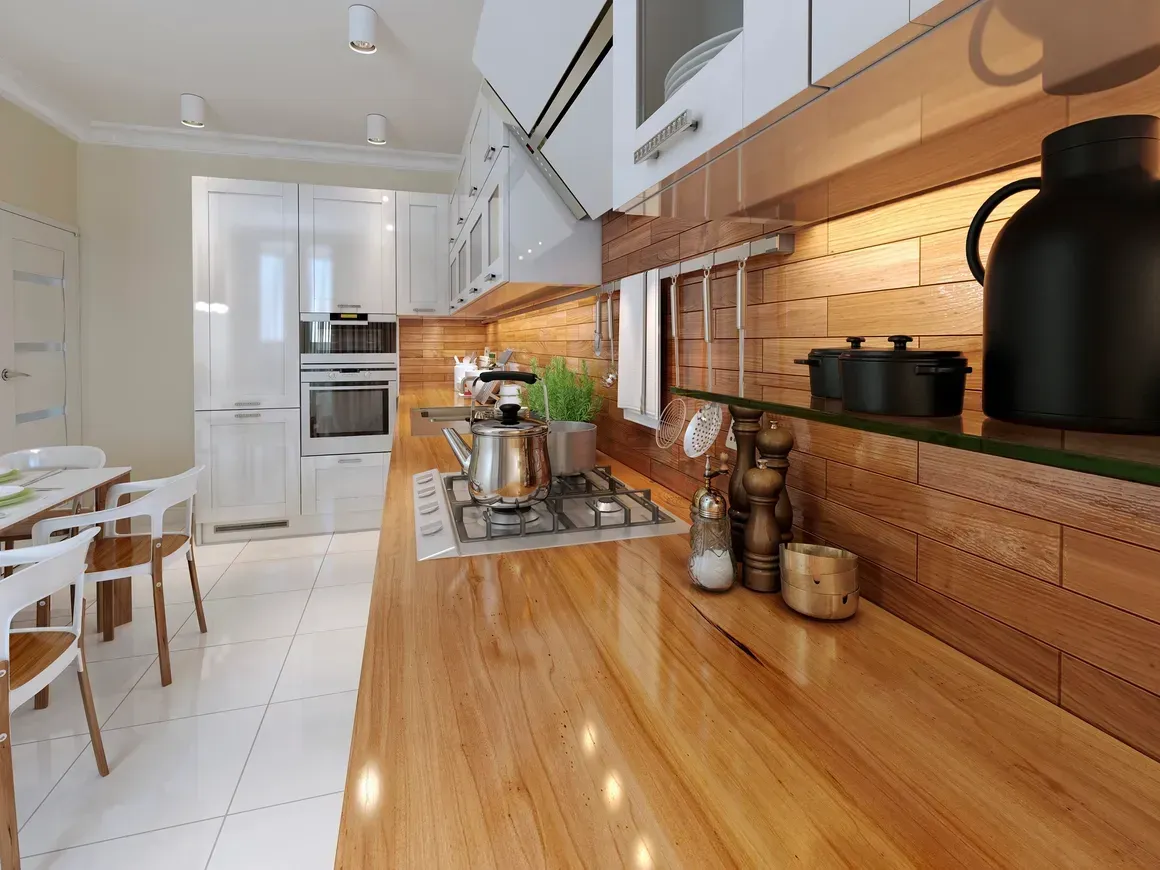 A kitchen with a wooden counter top and white cabinets.