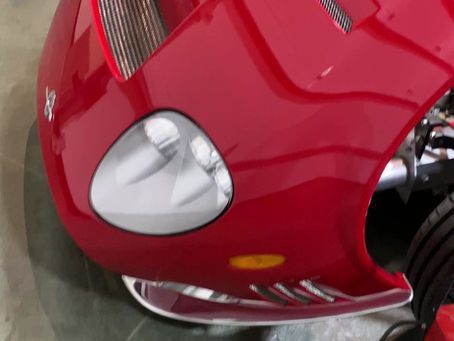 A close up of the front of a red motorcycle