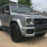 A mercedes benz g63 is parked in a driveway.