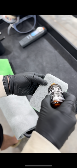A blue sports car is parked in a garage