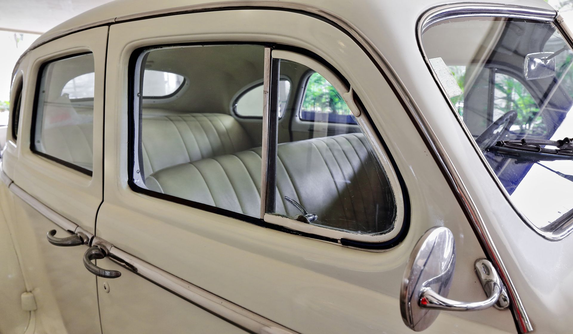 A close up of a white car with the door open.