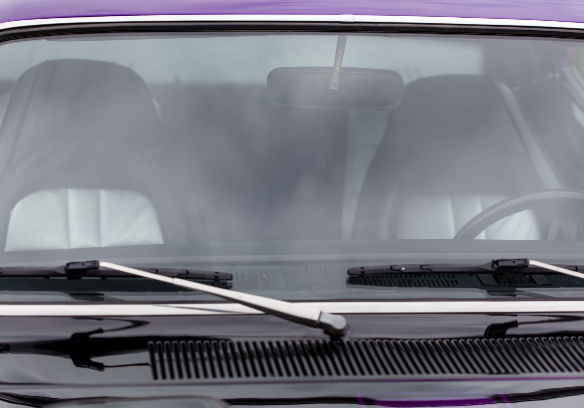 A close up of the windshield of a purple car