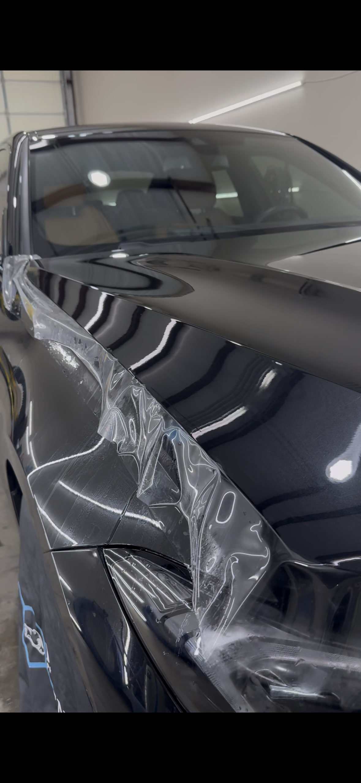 A man is working on a car with a wrench.