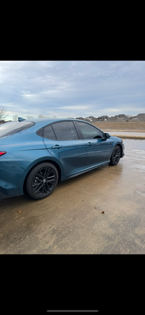 A silver car with a white license plate on a white background