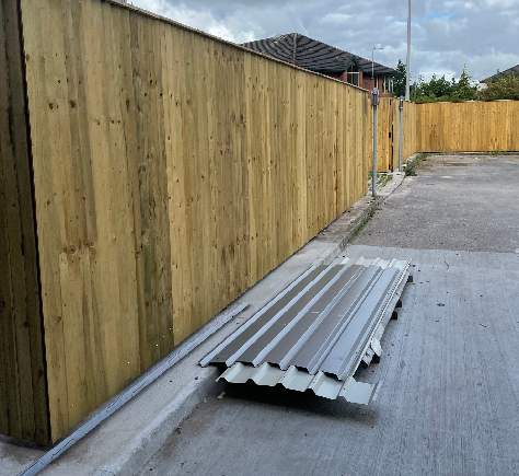 a man with a beard is using a drill on a wall .