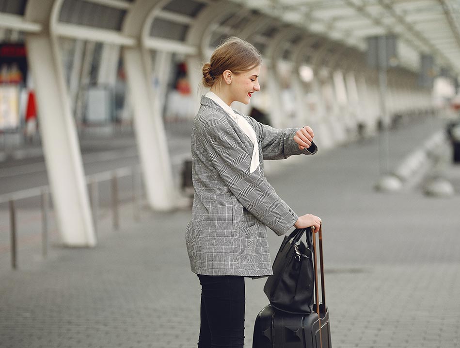 Happy Woman Waiting At The Airport — Limo Hire in Gold Coast, QLD
