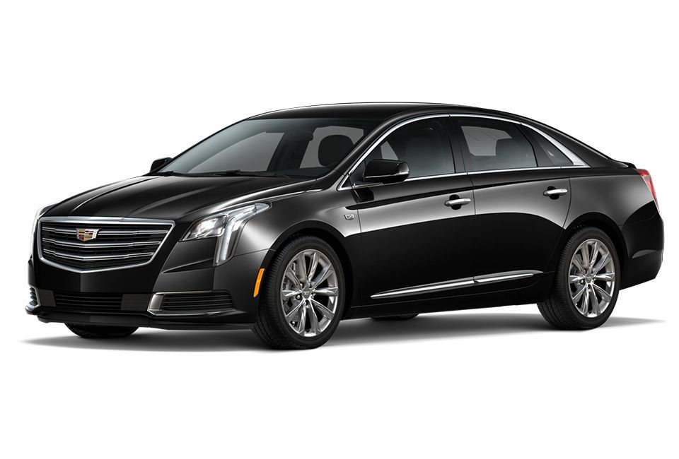 Black Cadillac XTS sedan, parked, front view.