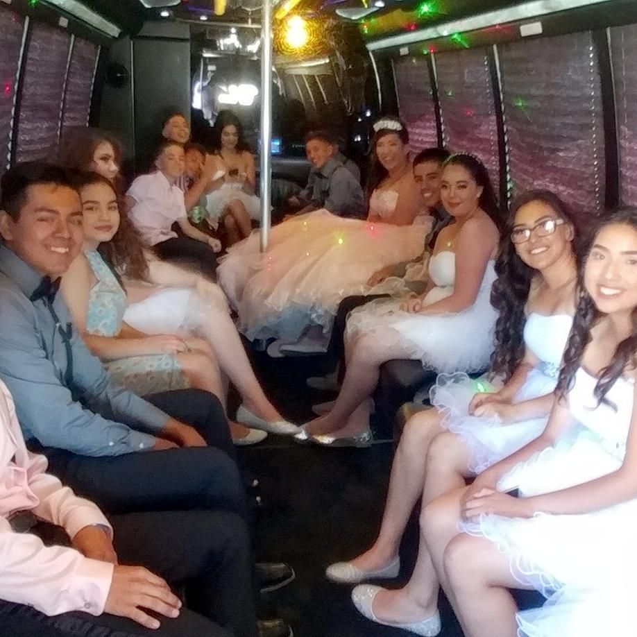 A group of people are sitting in a party bus