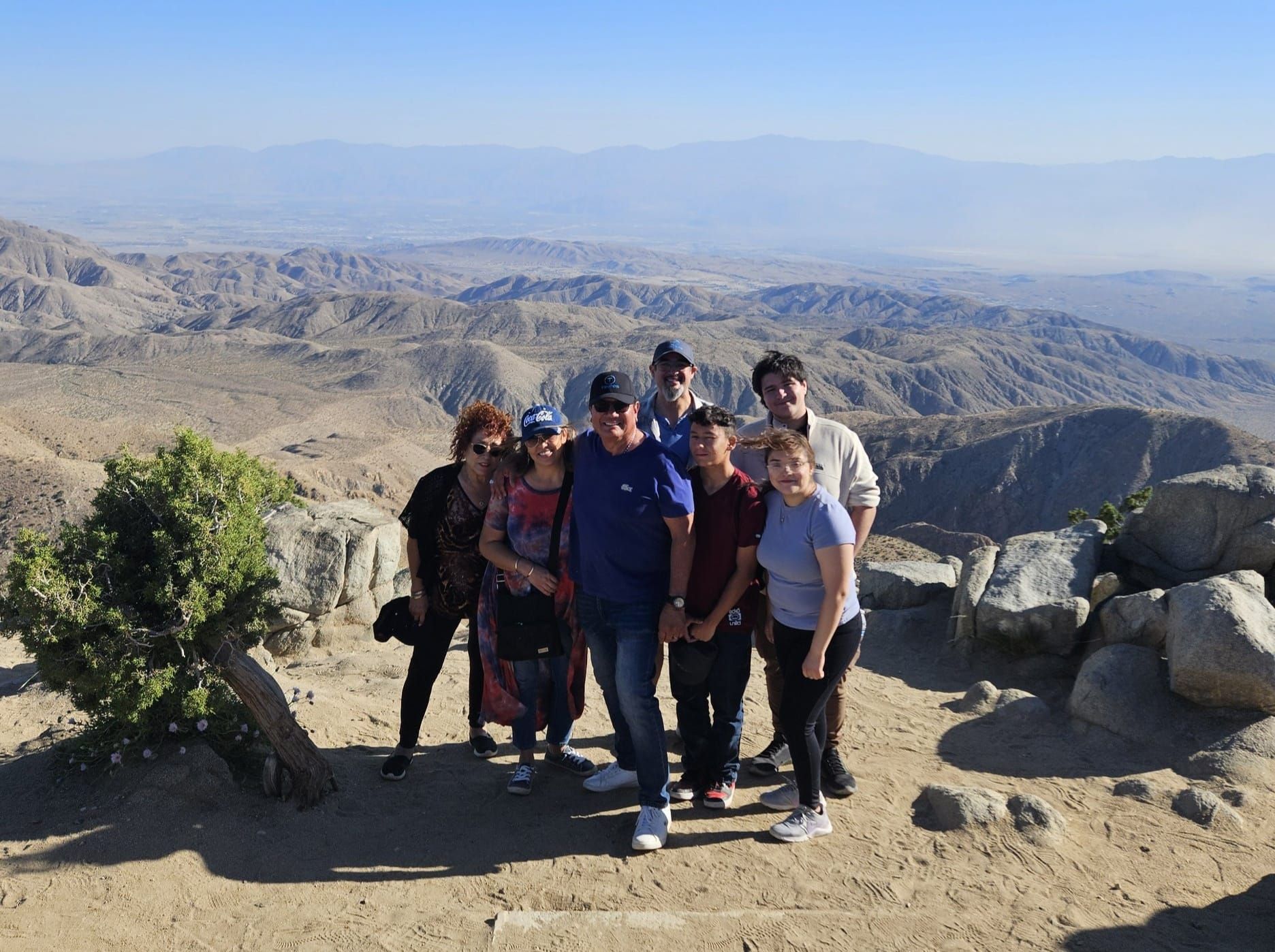 A sign for joshua tree national park is under a starry night sky.