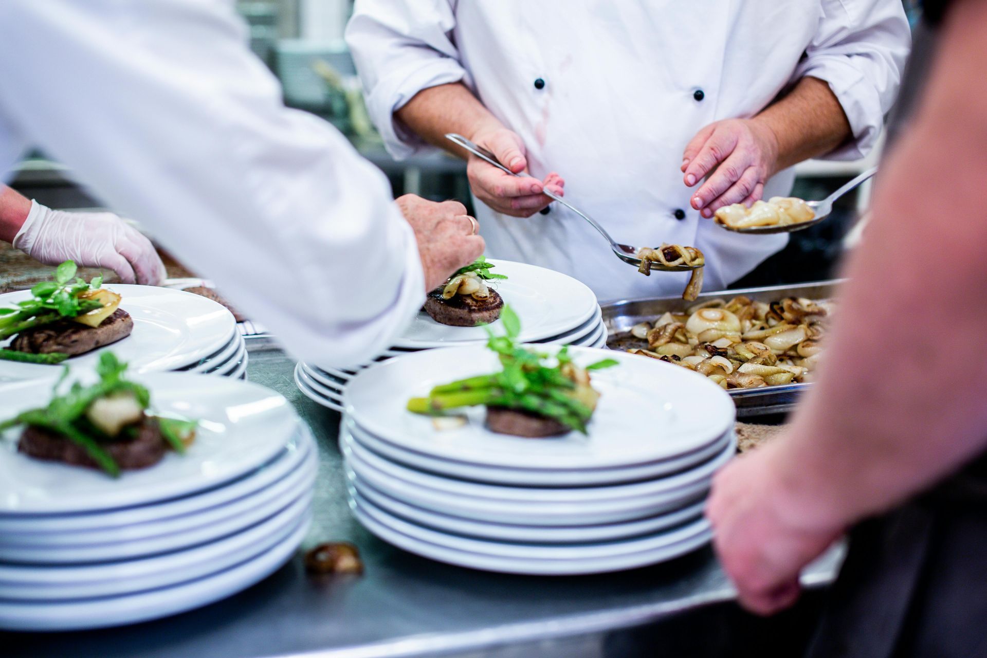 A group of chefs are preparing food in a kitchen.